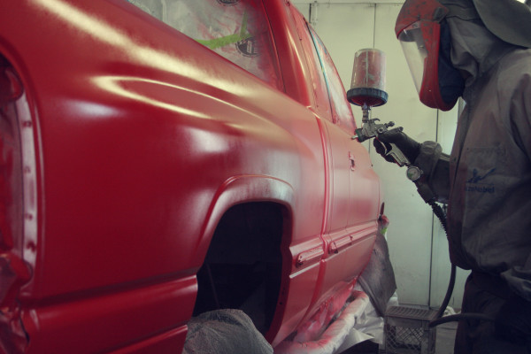 Pick-up truck in paint booth being painted 2